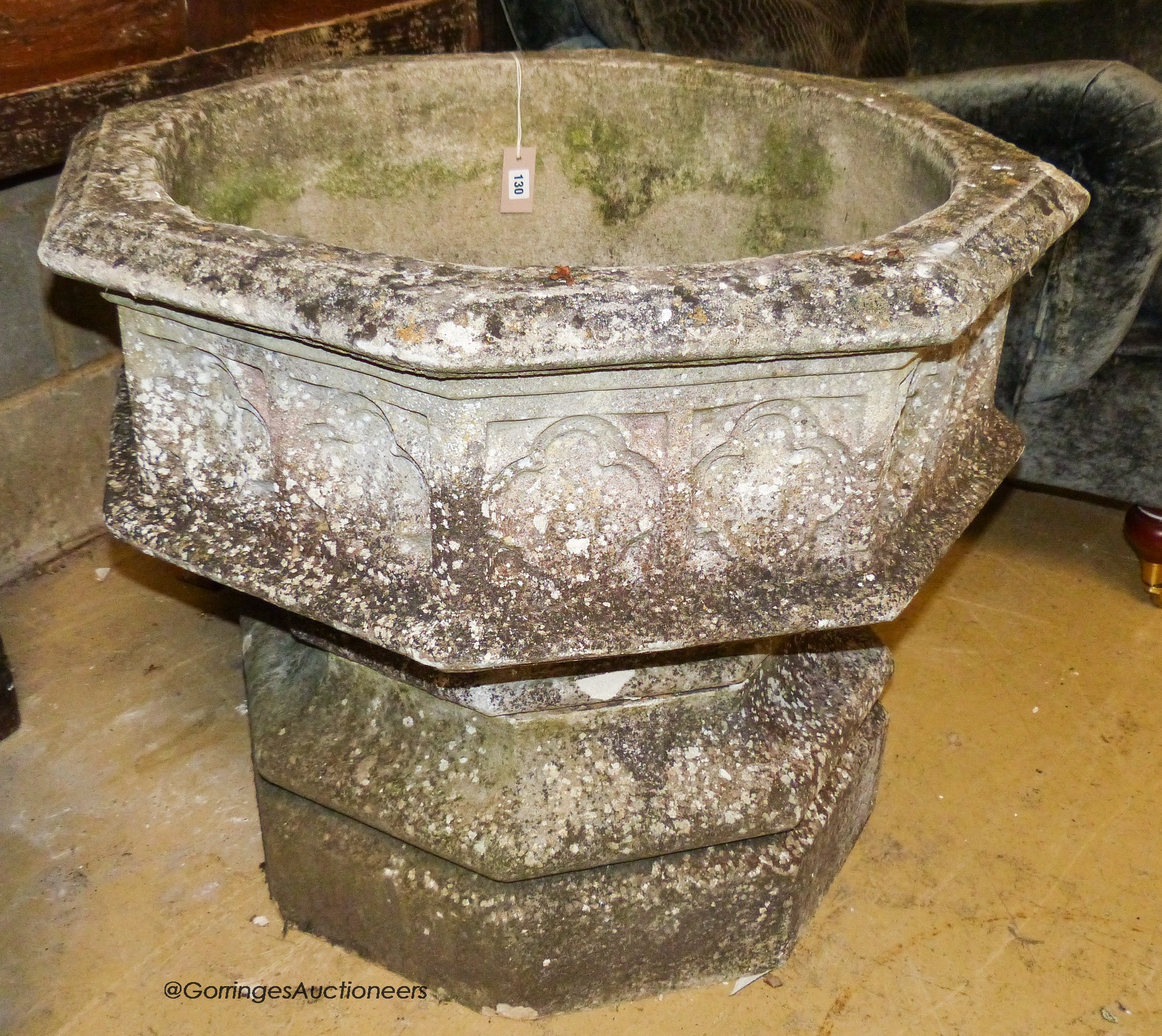 A large weathered Victorian octagonal carved stone font, width 80cm, height 67cm